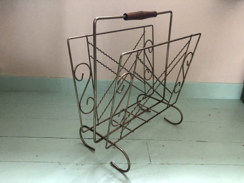 Rack is sitting on a turquoise green wooden floor.